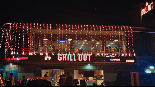 Chef grilling food at GrillOut restaurant